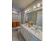 Bathroom featuring double sinks with a white countertop and a shower with an orange curtain at 2310 Raven Ridge Rd, Minneola, FL 34715