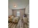 Bedroom with laminate floors, a window, neutral colors, and a closet at 2310 Raven Ridge Rd, Minneola, FL 34715