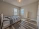 Bedroom with wood-look floors, neutral walls, and a big window with natural light at 2310 Raven Ridge Rd, Minneola, FL 34715