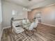 Contemporary dining room featuring a glass table, six white chairs, and stylish decor at 2310 Raven Ridge Rd, Minneola, FL 34715