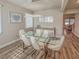 Elegant dining area with modern lighting, seating for six, and contemporary artwork at 2310 Raven Ridge Rd, Minneola, FL 34715