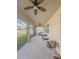 Covered patio area with ceiling fans and outdoor seating, perfect for relaxing and entertaining at 2310 Raven Ridge Rd, Minneola, FL 34715
