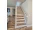 Bright staircase featuring wood stairs, white risers, and matching trim; natural light from the window at 2310 Raven Ridge Rd, Minneola, FL 34715