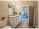 Bright bathroom with granite counters, dual sinks, and a shower with modern fixtures at 248 Cheshire Ct, Kissimmee, FL 34758
