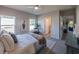 Modern bedroom with neutral tones, plush bedding, and a ceiling fan for added comfort at 248 Cheshire Ct, Kissimmee, FL 34758