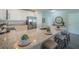 Kitchen featuring granite counters and eat-in bar with modern faucet and stainless steel appliances at 248 Cheshire Ct, Kissimmee, FL 34758