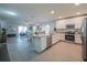 Open kitchen featuring granite countertops, stainless steel appliances and views into the living room at 248 Cheshire Ct, Kissimmee, FL 34758