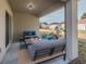 Cozy outdoor patio with modern furniture, providing a relaxing space with a view of the backyard at 248 Cheshire Ct, Kissimmee, FL 34758
