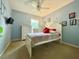 Comfortable bedroom with a full bed, dresser, soft blue walls, and ample natural light at 2788 Sun Key Pl, Kissimmee, FL 34747