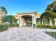 Inviting clubhouse featuring manicured landscaping, lush greenery, and architectural detail at 2788 Sun Key Pl, Kissimmee, FL 34747