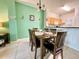 Inviting dining room with a wooden table and chairs, complemented by a view into the adjacent kitchen at 2788 Sun Key Pl, Kissimmee, FL 34747