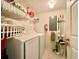Functional laundry room with a washer, dryer, shelving, and storage options for convenience at 2788 Sun Key Pl, Kissimmee, FL 34747