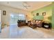 Cozy living room with comfortable sofas, tile flooring, and natural light streaming through sliding glass doors at 2788 Sun Key Pl, Kissimmee, FL 34747