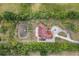 This aerial view showcases home and acreage, featuring a private pond at 2841 S Lloyd Ln, Kissimmee, FL 34744