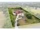 This aerial view showcases home and acreage, highlighted by a property line at 2841 S Lloyd Ln, Kissimmee, FL 34744