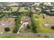 This aerial view showcases home and acreage, surrounded by lush foliage at 2841 S Lloyd Ln, Kissimmee, FL 34744