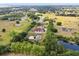 This aerial view showcases home and acreage, featuring a private pond at 2841 S Lloyd Ln, Kissimmee, FL 34744