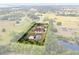 This aerial view showcases home and acreage, highlighted by a property line at 2841 S Lloyd Ln, Kissimmee, FL 34744