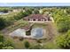 Aerial shot features backyard pond with gazebo and lush landscaping at 2841 S Lloyd Ln, Kissimmee, FL 34744