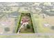 This aerial view showcases home and acreage, highlighted by a property line at 2841 S Lloyd Ln, Kissimmee, FL 34744