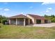 Expansive backyard featuring a brick patio, enclosed screened area, and ample green space for outdoor activities at 2841 S Lloyd Ln, Kissimmee, FL 34744