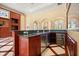 Wet bar features stainless steel appliances, dark countertops, and beautiful wood cabinetry at 2841 S Lloyd Ln, Kissimmee, FL 34744