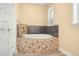 Bathroom featuring a soaking tub with decorative tile at 2841 S Lloyd Ln, Kissimmee, FL 34744
