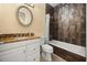 Bathroom featuring granite countertop, vanity, and shower with dark tile surround at 2841 S Lloyd Ln, Kissimmee, FL 34744