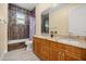Bathroom featuring double sink vanity with granite countertop, and tile shower at 2841 S Lloyd Ln, Kissimmee, FL 34744