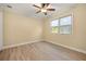 Bedroom featuring beautiful light wood flooring, a ceiling fan, and a window view at 2841 S Lloyd Ln, Kissimmee, FL 34744