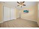 Bedroom featuring light wood flooring, a ceiling fan, closet, and TV at 2841 S Lloyd Ln, Kissimmee, FL 34744