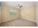 Bright bedroom with wood flooring, ceiling fan and a window for natural light at 2841 S Lloyd Ln, Kissimmee, FL 34744