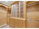 Custom closet with built-in drawers and glass-front cabinets at 2841 S Lloyd Ln, Kissimmee, FL 34744
