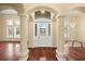 Grand foyer featuring high ceilings, decorative columns, hardwood floors, and an elegant chandelier at 2841 S Lloyd Ln, Kissimmee, FL 34744