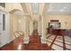 Elegant foyer with soaring ceilings, decorative columns, hardwood floors, custom flooring, and a beautiful chandelier at 2841 S Lloyd Ln, Kissimmee, FL 34744