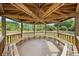 Interior view of a wooden gazebo with a roof, benches and a view of the property at 2841 S Lloyd Ln, Kissimmee, FL 34744