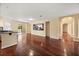 Open floor plan with hardwood floors, access to the lanai, and a stylish wet bar at 2841 S Lloyd Ln, Kissimmee, FL 34744