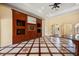 Spacious living room with a decorative tile floor, custom built-ins, and an open view of the foyer at 2841 S Lloyd Ln, Kissimmee, FL 34744