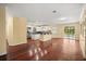 Open floor plan with hardwood floors seamlessly connects the living area to the kitchen at 2841 S Lloyd Ln, Kissimmee, FL 34744