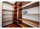 Spacious walk-in pantry featuring custom wood shelving for ample storage at 2841 S Lloyd Ln, Kissimmee, FL 34744