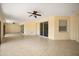 Large covered patio featuring tile flooring, ceiling fans and multiple glass sliding door access points at 2841 S Lloyd Ln, Kissimmee, FL 34744
