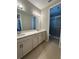 Bathroom featuring double sinks and a glass shower at 2920 Agostino Ter, Kissimmee, FL 34746