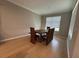 Cozy dining room with hardwood floors, table with unique wooden chairs at 2920 Agostino Ter, Kissimmee, FL 34746