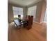 Dining room with hardwood floors, table with unique wooden chairs and bench at 2920 Agostino Ter, Kissimmee, FL 34746