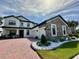 Elegant two-story home featuring a brick driveway, attached two-car garage and beautifully landscaped front yard at 2920 Agostino Ter, Kissimmee, FL 34746