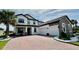 Elegant two-story home featuring a brick driveway, attached two-car garage and beautifully landscaped front yard at 2920 Agostino Ter, Kissimmee, FL 34746