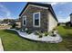 Close up of the manicured lawn with stone accents and landscaping around home's exterior at 2920 Agostino Ter, Kissimmee, FL 34746