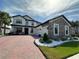 Elegant two-story home featuring a brick driveway, attached two-car garage and beautifully landscaped front yard at 2920 Agostino Ter, Kissimmee, FL 34746