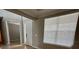 Bright foyer with front door and large window, showcasing the home's entrance and open floor plan at 2920 Agostino Ter, Kissimmee, FL 34746