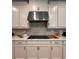 Kitchen featuring white cabinets, stainless steel appliances, and light countertops at 2920 Agostino Ter, Kissimmee, FL 34746